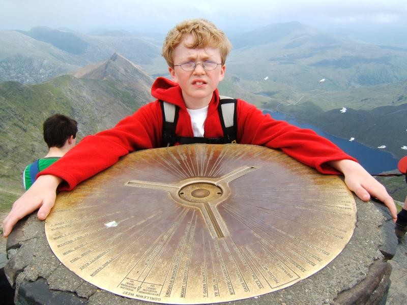 Adam and the ornate brass triangulation plaque at the top of
