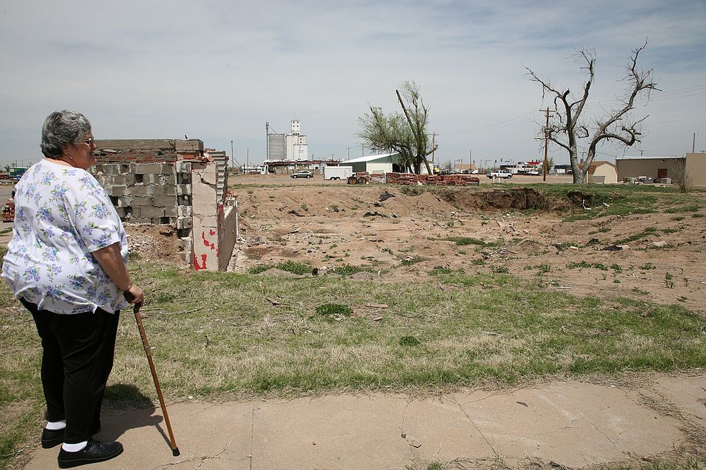 54. Woman surveying destroyed church, Greensburg, Kansas 996