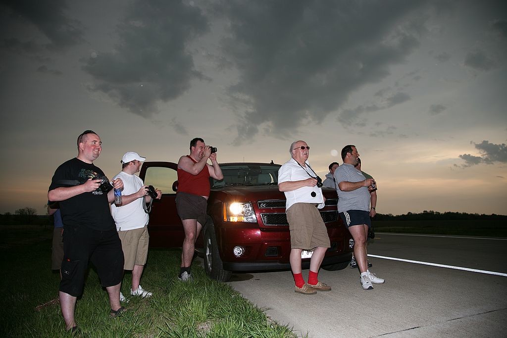 52. The team gathers to watch the action, near Fredonia, Kan
