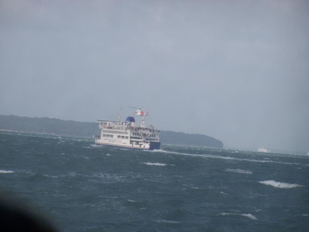 helicopter hovering over car ferry on way to isle of wight